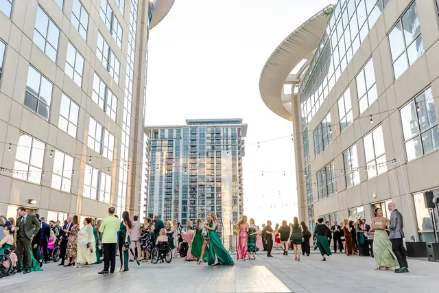Rooftop reception beneath string lights at the 2025 Goodness Gala