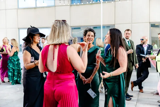 Guests chatting during the rooftop reception at the 2025 Goodness Gala
