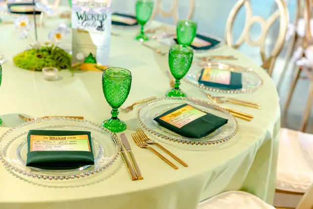 Green glassware and place settings on a gala table at the 2025 Goodness Gala
