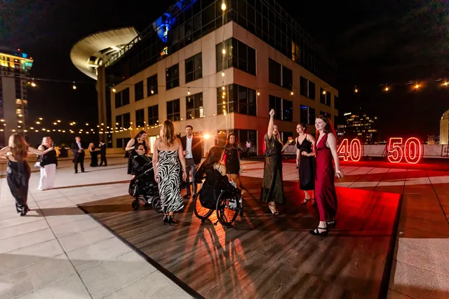 Guests enjoying the rooftop at night at the 2026 Goodness Gala