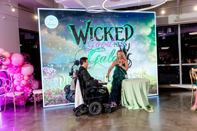 Presenters in front of the Wicked For Goodness Gala screen at the 2025 Goodness Gala